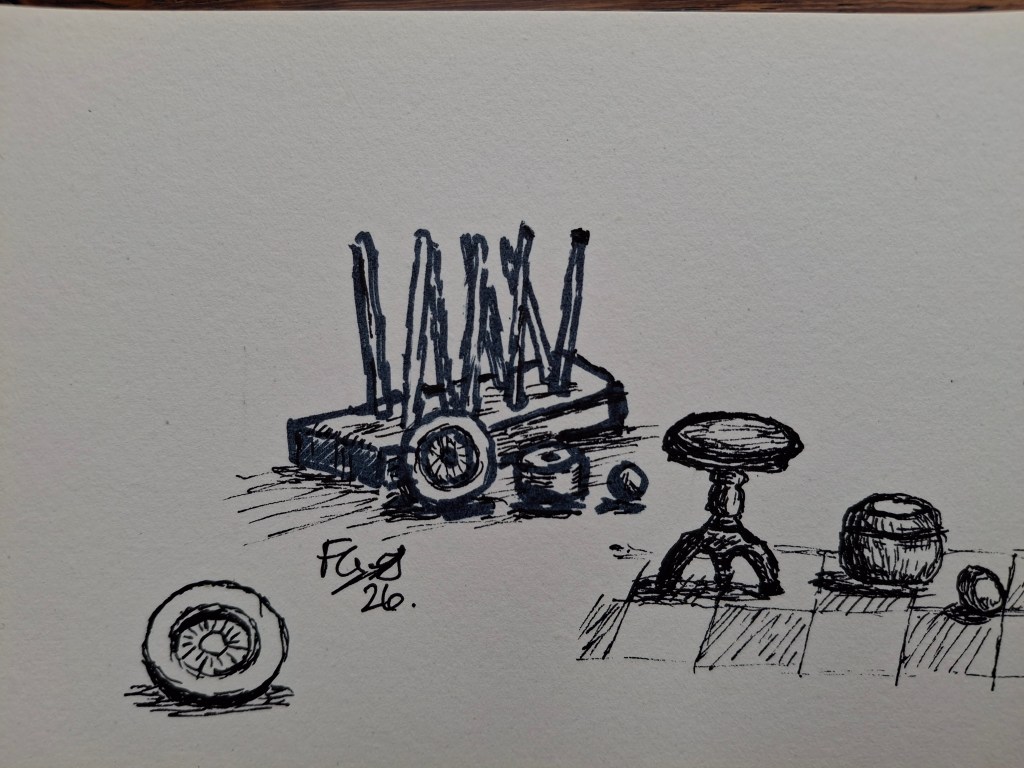 pen and ink sketch of various small wooden objects including a welly boot stand and a perpetual calendar